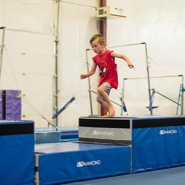 young boy doing an obstacle course