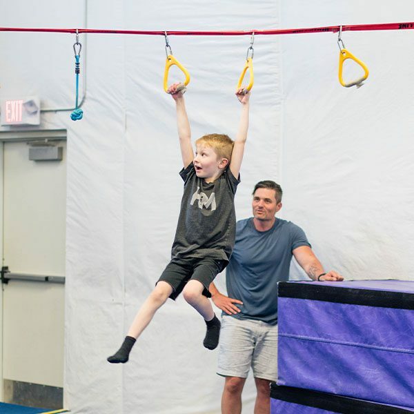 young boy on the rings